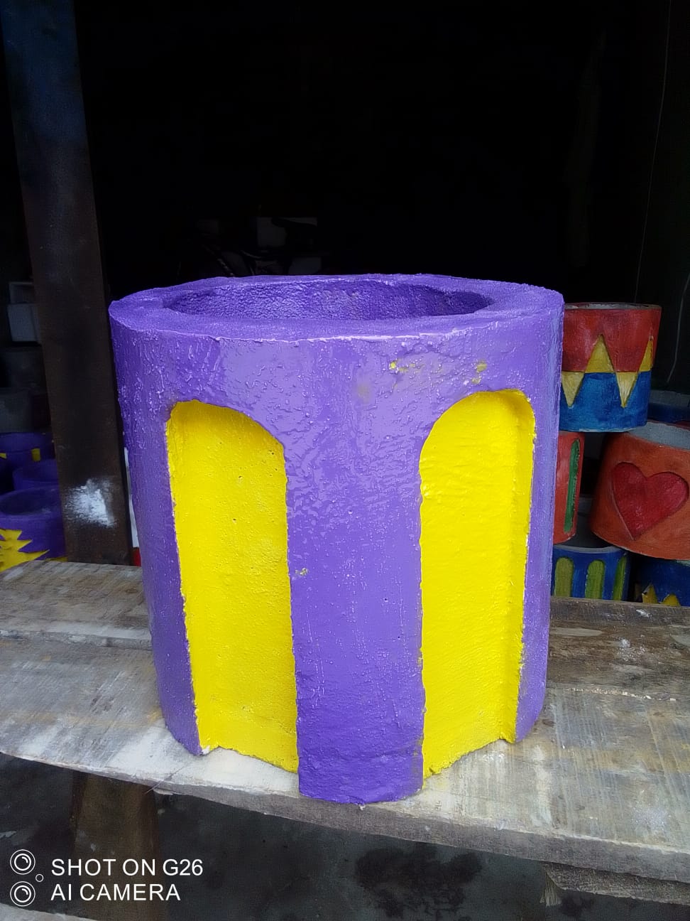WhatsApp Image 2026-08-06 at 16.36.26 Arch-Cut Cement Planter – Purple & Yellow